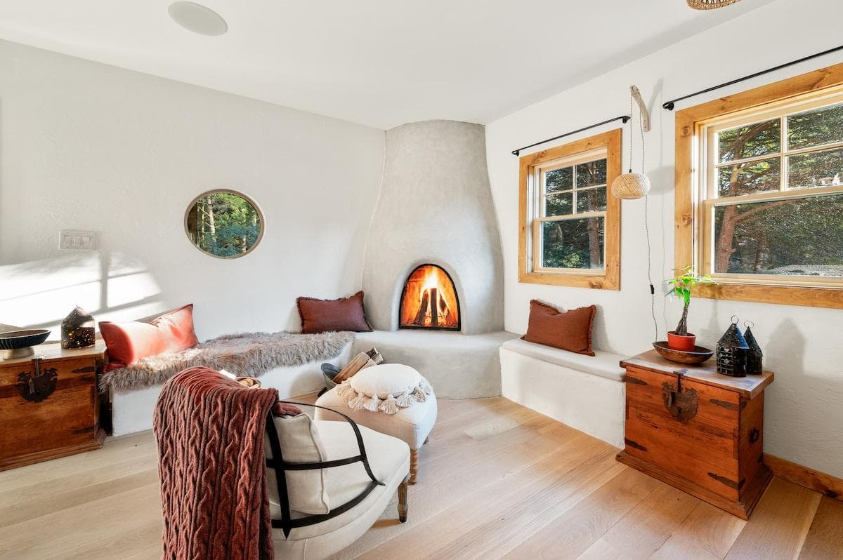 Spacious living room with plenty of seating and adobe fireplace